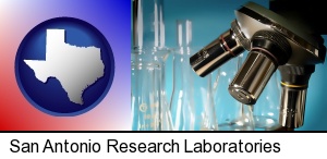 a microscope and glassware in a research laboratory in San Antonio, TX