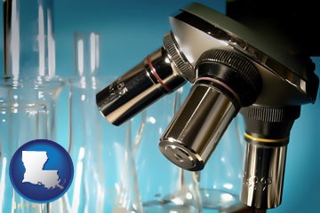 a microscope and glassware in a research laboratory - with Louisiana icon
