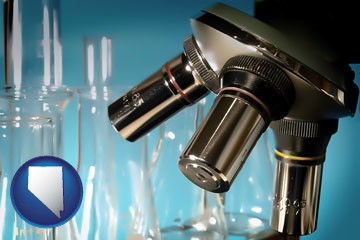 a microscope and glassware in a research laboratory - with Nevada icon