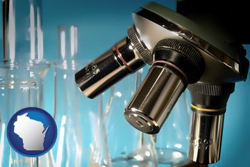 a microscope and glassware in a research laboratory - with Wisconsin icon
