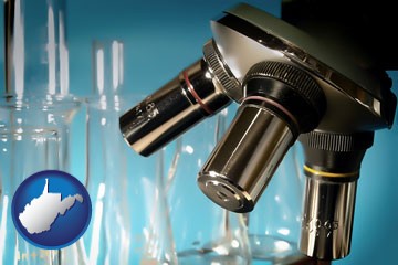 a microscope and glassware in a research laboratory - with West Virginia icon