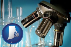 rhode-island map icon and a microscope and glassware in a research laboratory